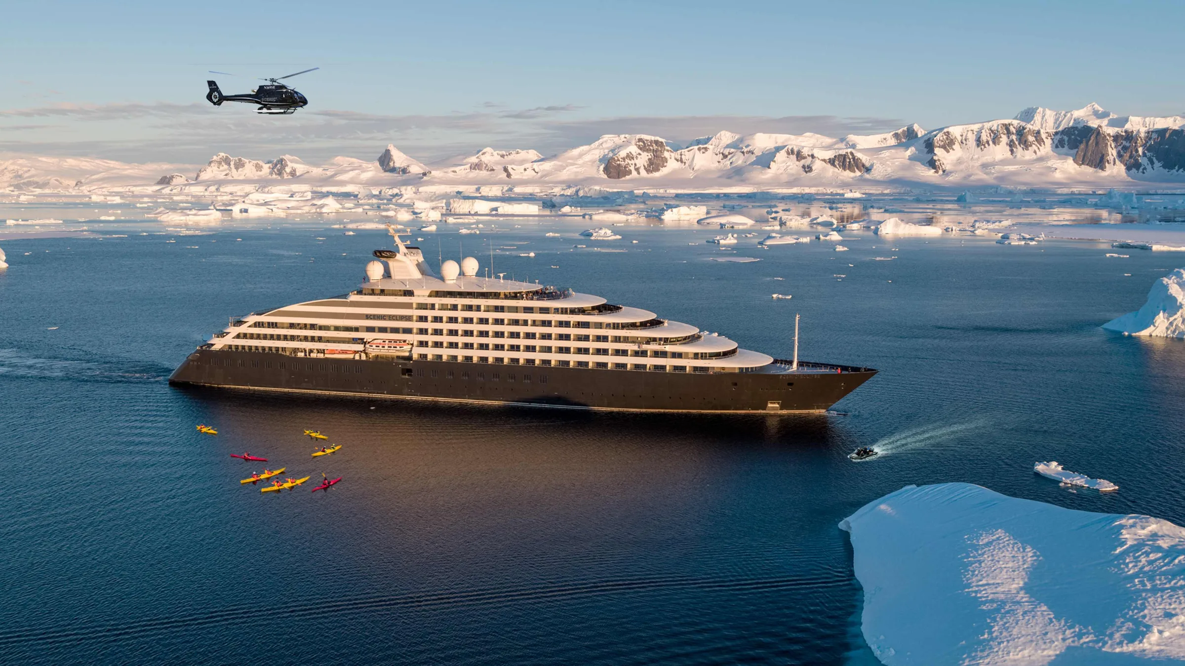 Scenic Eclipse expedition yacht in Antarctica with helicopter and kayakers near The Gullet
